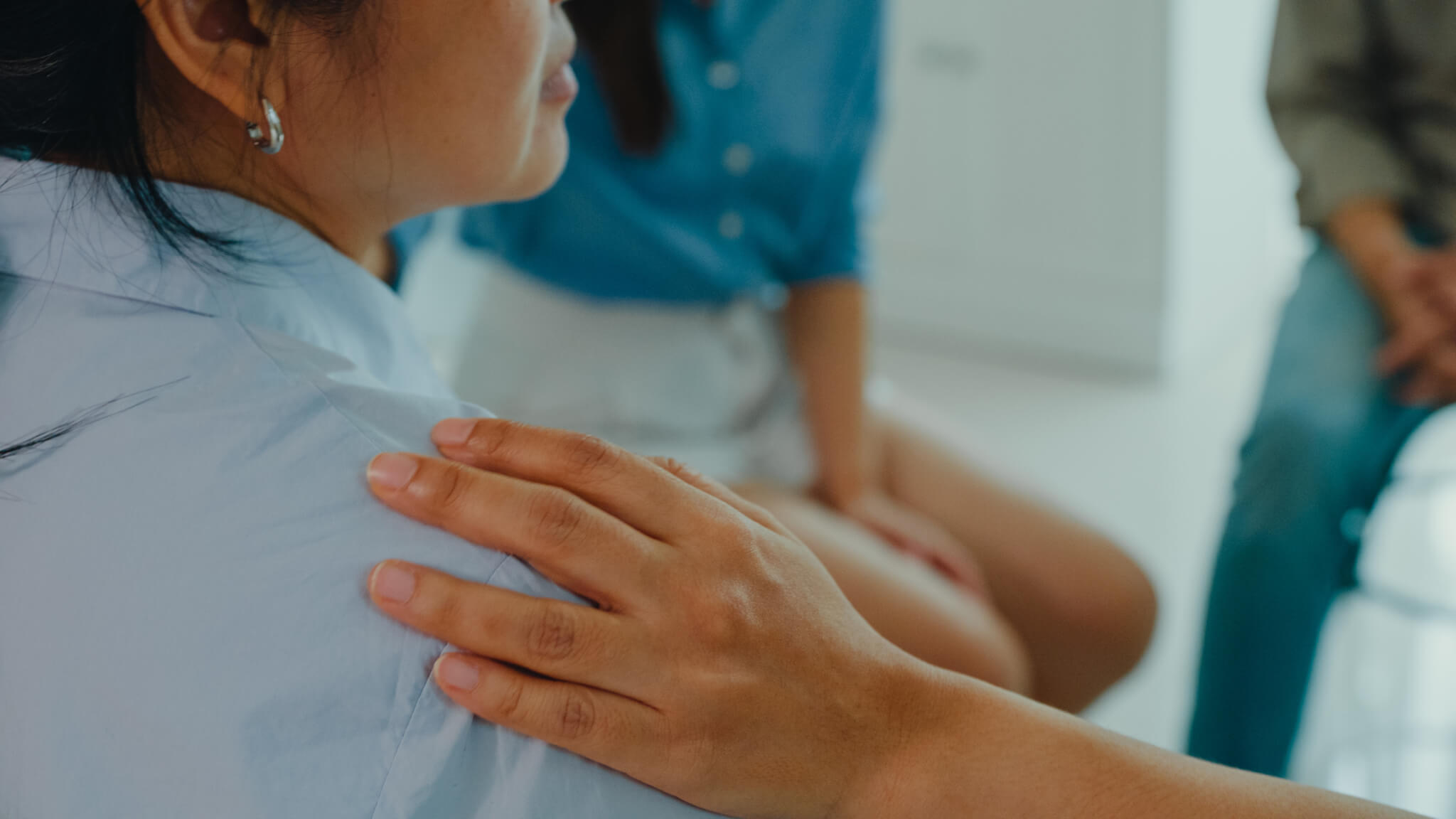 Close-up of a group of psychotherapists talking, calming, and soothing a female from mental health problems. People use group therapy to support each other in recovering from the sadness concept.