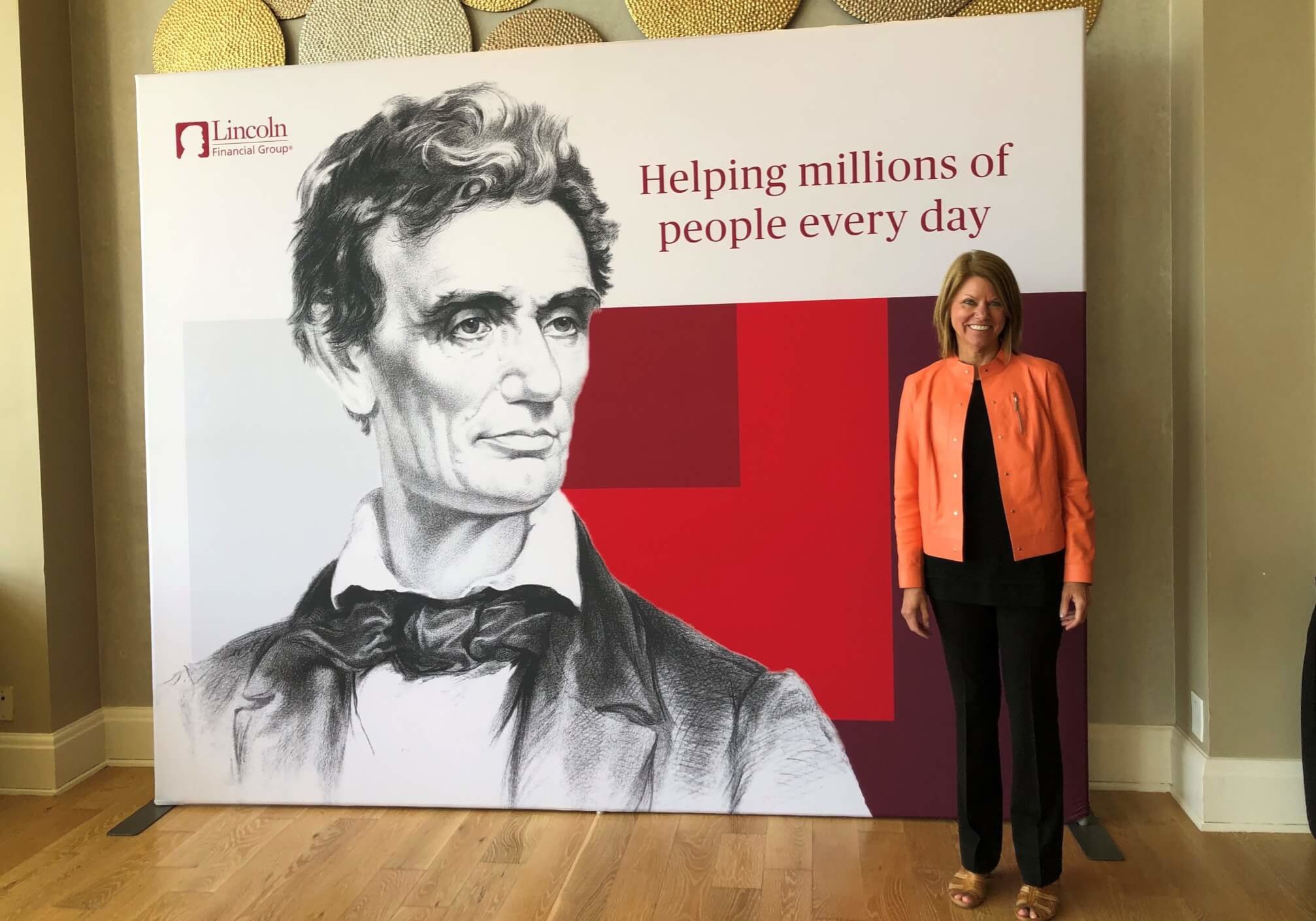 Carol Seymour standing in front of a Araham Lincoln poster